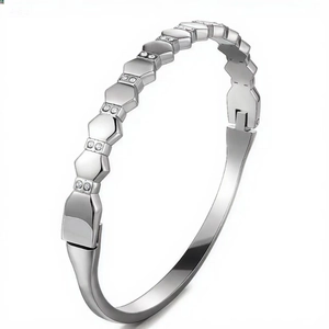 Detail of silver titanium steel bangle with honeycomb hexagonal pattern and zircon inlay