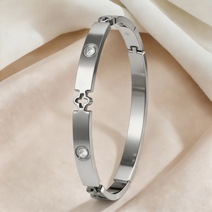 Polished silver stainless steel clover bracelet with sparkling cubic zirconia accents