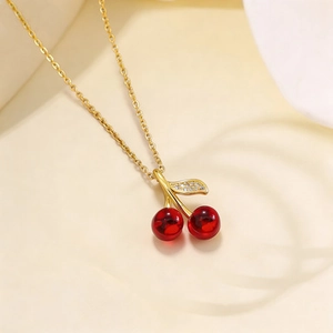 Titanium steel necklace with cherry pendant and sparkling leaves on gold chain