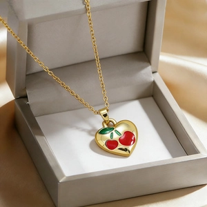 Titanium gold heart necklace with red enamel cherry pendant in a jewelry gift box