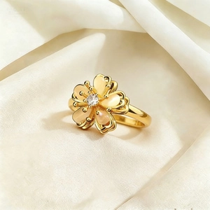 Detail of gold-plated spinning ring with flower cat eye stone and cubic zirconia center