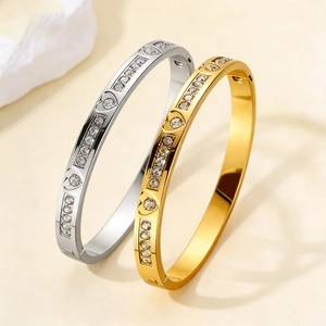 Detail of heart-engraved titanium steel bangles with sparkling inlaid zircons
