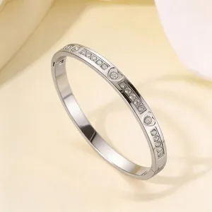 Detailed view of silver titanium steel heart bracelet with embedded cubic zirconia crystals