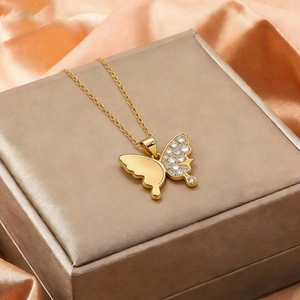 Elegant gold titanium butterfly necklace with white zircon pendant on jewelry box