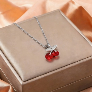 Titanium steel cherry pendant necklace with red crystals on a luxury champagne gift box