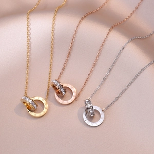 Three interlocking double ring necklaces in gold rose gold and silver on pink silk