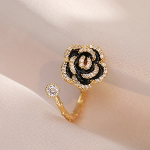 Adjustable gold branch ring with a black rose centerpiece and sparkling crystals