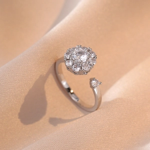Elegant rotating flower ring set in silver stainless steel with zircon petal details