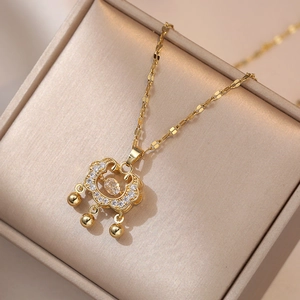 Golden Ruyi lock necklace with pavé zircons and three dangling beads on velvet