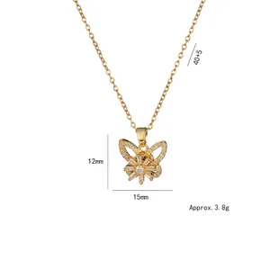 Detailed view of rotating zircon butterfly pendant with dimensions 12mm x 15mm on a gold chain