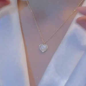Titanium steel heart necklace with cubic zirconia pendant shown on female model