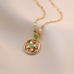 Cat's eye stone windmill pendant necklace with gold hollow pattern and zircon accents