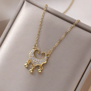 Vintage golden long life lock necklace with zircon stones and bead charms on a jewelry box