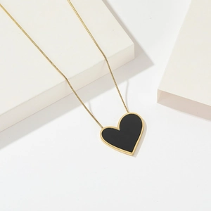 Minimalist titanium steel necklace with an asymmetrical black heart pendant and gold chain