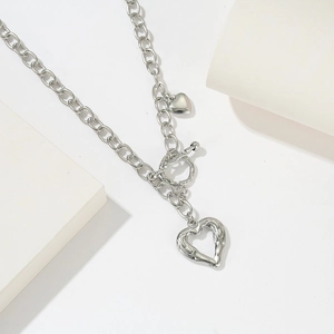 Titanium steel heart pendant necklace with lava texture and OT toggle clasp on white tray