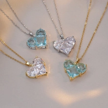 Close-up of heart-shaped crystal pendant necklaces in various colors and finishes