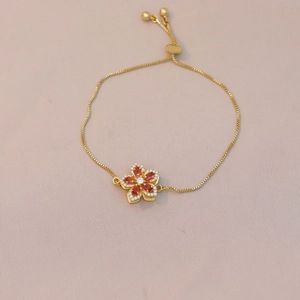 Adjustable golden bracelet with red zircon flower pendant and white crystal accents