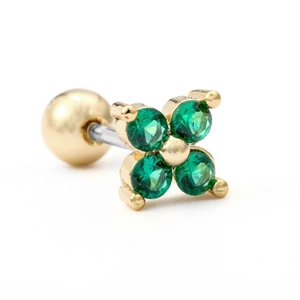 Macro shot of green clover stud earring with emerald-colored cubic zirconia and gold ball
