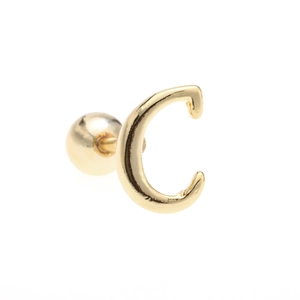 Detailed close-up of 18K gold letter C piercing stud with a round screw ball back