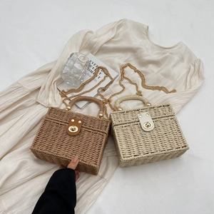 Handmade woven rattan crossbody bags in brown and beige colors with gold chain straps