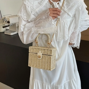 Elegant rectangular cream straw handbag with gold chain strap and metal swivel lock