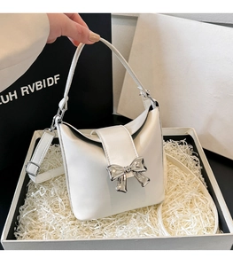White bucket bag with silver bow accent presented in a premium gift box packaging