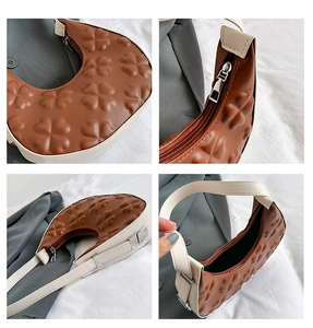 Detailed views of caramel hobo bag showing clover embossing and premium stitching details