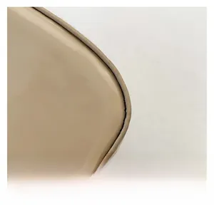 Detailed close-up of smooth beige faux leather texture with precise stitching for handbag