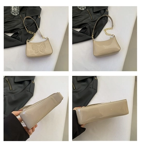Detail view showing beige patent leather butterfly embossing and gold chain strap
