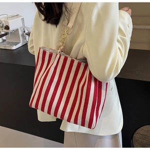 Retro striped canvas tote bag with red and white patterns and gold chain straps