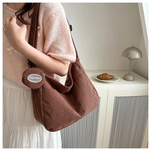 Brown corduroy hobo bag with a matching detachable small coin pouch on a side strap