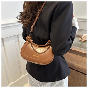 Brown moon-shaped shoulder bag featuring decorative knotted handle and golden hardware