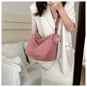 Pink corduroy crossbody bag with adjustable strap and matching round coin purse detail