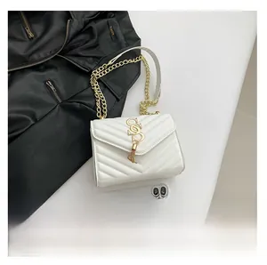 Close-up of white quilted leather bag with V-pattern stitching and gold tassel metal hardware