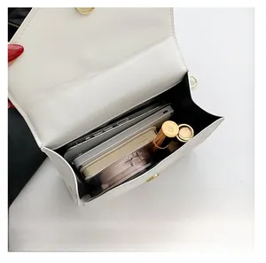 Interior view of white leather crossbody bag showing large capacity for phone and cosmetics