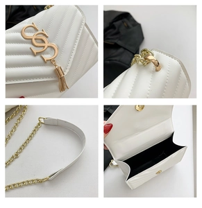Macro views of white quilted bag features V-stitches gold logo and chain strap details