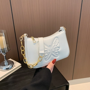 White faux leather underarm bag with butterfly embossing and gold chain strap