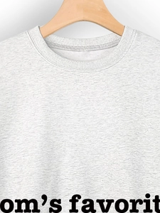 Close-up of heather grey crewneck sweatshirt with ribbed collar and soft knit texture