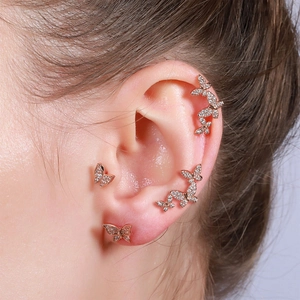 Close-up of 18K rose gold butterfly earrings with micro-set zircon stones on model ear