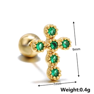 Macro detail of a 9mm gold cross stud earring with green zircons and ball screw back