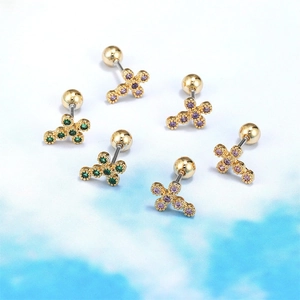 Golden star-cross stud earrings with colorful cubic zirconia on a blue background