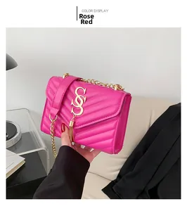 Detail of rose red quilted PU leather shoulder bag with gold chain and tassel decoration