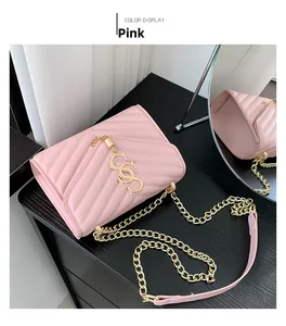 Detail of pink chevron quilted small square bag with gold chain strap and metal hardware