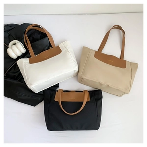 Large nylon tote bags in white, beige, and black with brown PU leather handles and fashion tag