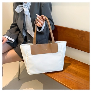 Minimalist bicolor nylon tote bag with brown leather handles and Fashion text