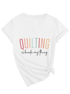 Close-up of V-neck white cotton T-shirt featuring 'QUILTING is kinda my thing' graphic print