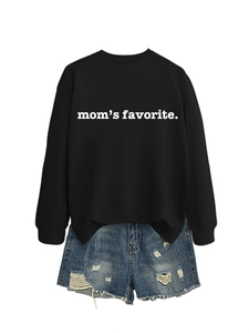 Detail of black crewneck sweatshirt with 'mom's favorite' text and distressed denim shorts