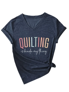 Flat lay of a grey V-neck T-shirt with QUILTING IS KINDA MY THING text and a knotted hem