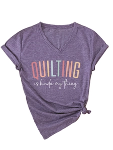 Detail of purple V-neck T-shirt with rainbow quilting quote and side-tie knot hemline