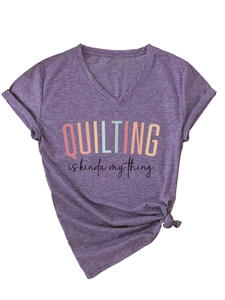 Detail of purple V-neck T-shirt with 'Quilting is kinda my thing' print and side knot